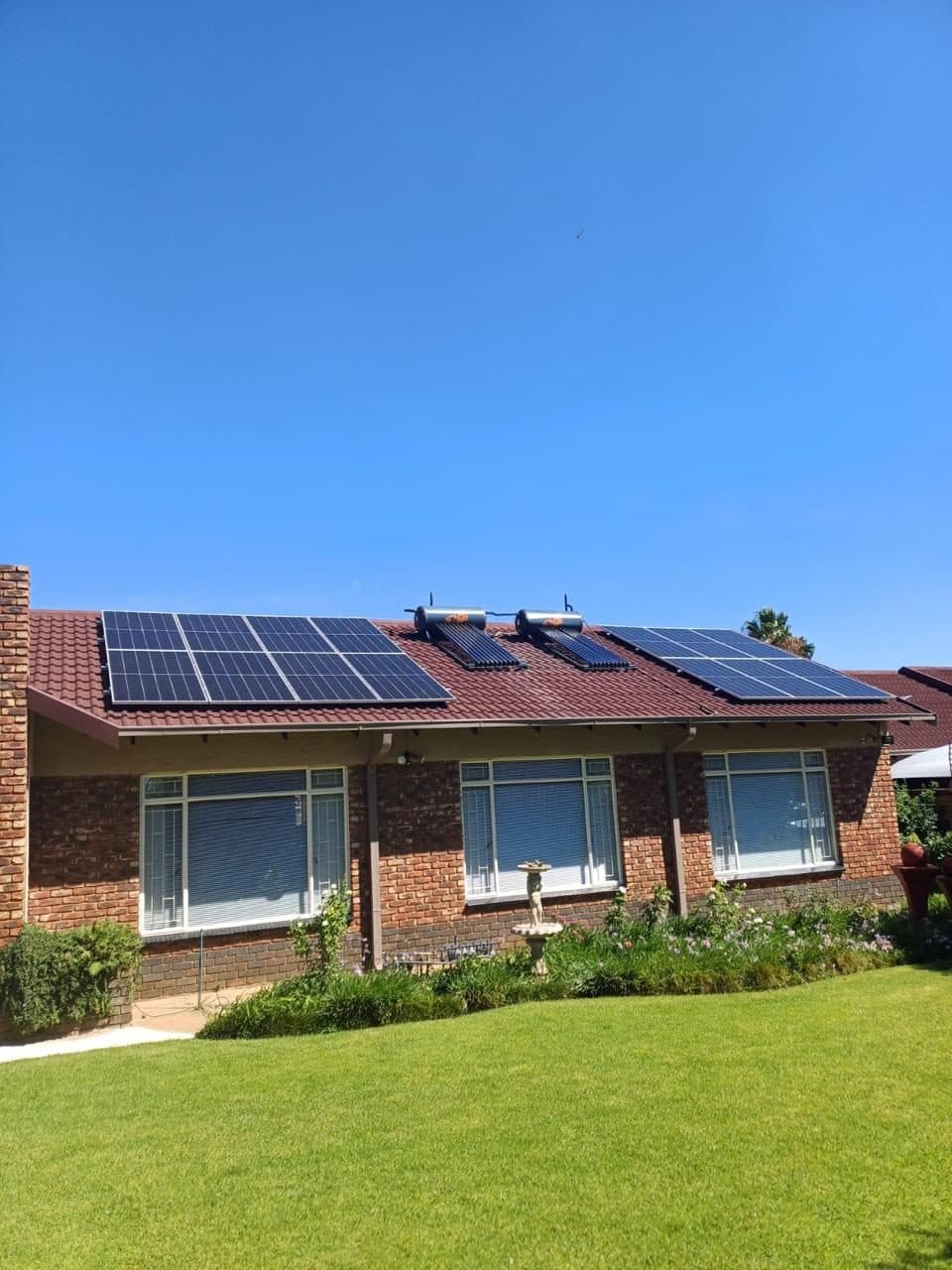 Rooftop solar panels and solar geysers installed on a family home by Sky Projects